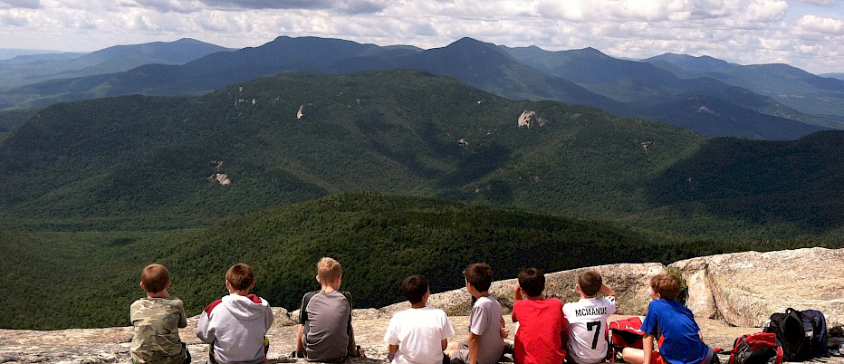A group of camp friends share a spectacular summit view.  And although their time together at the summit is short, they will share the memories of this trip together forever.