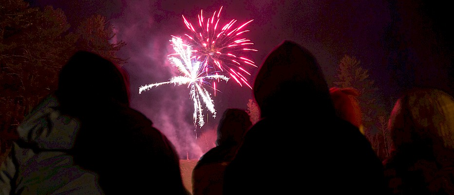 Campers during President Week enjoy the fireworks display at the base of King Pine.